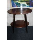 An Edwardian mahogany two-tier oval side table on square tapered legs, (LC)