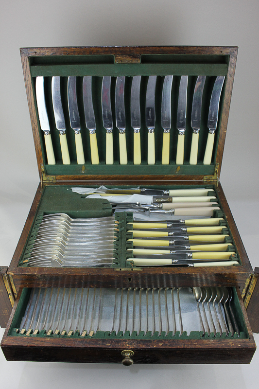 A silver plated part canteen for twelve in oak veneered canteen box with white handled knives