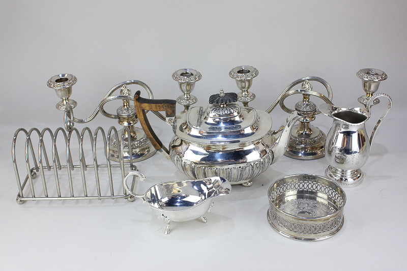 A Walker & Hall silver plated teapot, a pair of silver plated candlesticks, a large toast rack, a