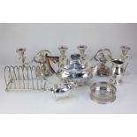 A Walker & Hall silver plated teapot, a pair of silver plated candlesticks, a large toast rack, a