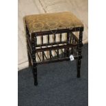 An upholstered piano stool with rectangular seat and music rack beneath, on turned supports, 44cm