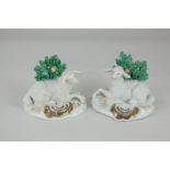 A pair of Staffordshire figures of resting sheep, with green bocage, 9cm