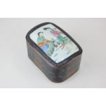 A Japanese black lacquered papier mache dressing table box, rectangular shape, porcelain inset top