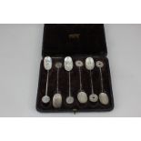 Two sets of three Chinese white metal spoons with character mark designs, bamboo style handles and