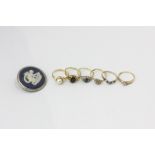 Five various gem set rings in 9ct gold mounts, a silver ring, a silver cameo brooch