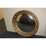 A circular gilt convex wall mirror, the frame with ball decoration, mirror plate 59.5cm diameter