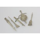 Four Scottish silver sword brooches, and a broom brooch