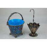 A silver plated umbrella cruet stand and a pierced bonbon dish with swing handle and blue glass