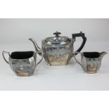 A three-piece silver plated tea set with chased design