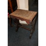 An Arts and Crafts carved rectangular occasional table with scrolling foliate decoration, central