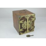 A Chinese brass bound wooden box with twin locking doors enclosing two drawers, with carry handle