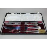 An Elizabeth II silver handled cased carving set, maker Henry Hutton & Co, Sheffield 1991, the