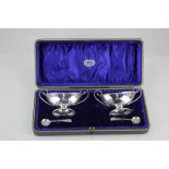 A cased pair of Edward VII silver boat shaped salt cellars, maker J Sherwood & Sons, Birmingham