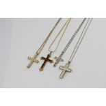 Four various gilt metal cross pendants