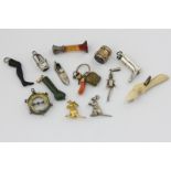 Thirteen various charms and pendants including gold, silver and various material examples, one by