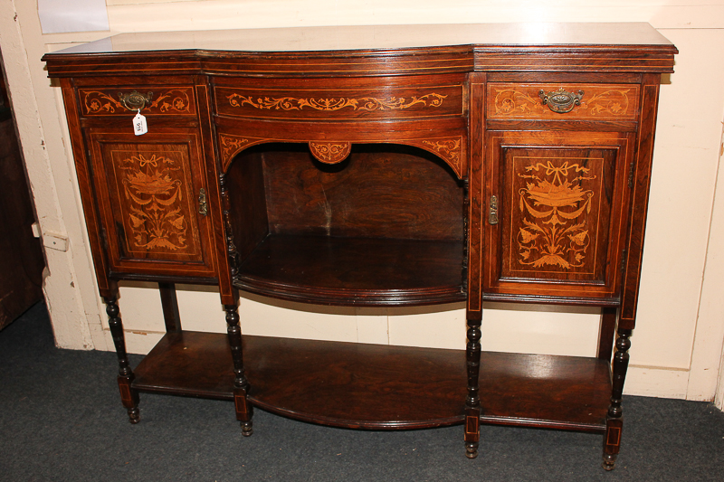A Victorian inlaid sideboard with central bow front shelf flanked by cupboards and drawers, on