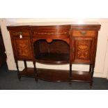 A Victorian inlaid sideboard with central bow front shelf flanked by cupboards and drawers, on