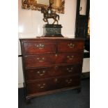 A George III oak chest of two short over three long graduated drawers with brass drop handles, on