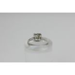 A diamond four-stone ring, claw set with princess cuts, in 18ct white gold