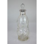 An Edward VII silver mounted glass decanter, maker's mark worn, London 1908, of swirl waisted