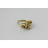 An 18ct gold and diamond ram's head ring with ruby eyes