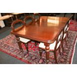 A set of eight Victorian style mahogany balloon back dining chairs with cream upholstered seats,