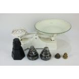 A pair of 20th century cream painted metal kitchen scales with a variety of weights, grams and