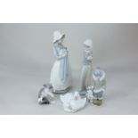 Two Nao porcelain figures of girls holding puppies, 25cm, two ducklings, a Lladro figure of a boy