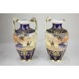 A pair of Noritake baluster urns depicting a figure riding a camel in the desert, 29cm high, (a/f)