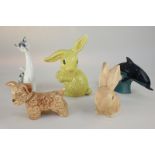 Two Sylvac pottery ornaments of rabbits (one a/f), a Poole Pottery dolphin, and two other animal