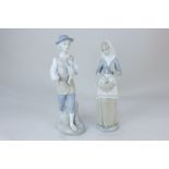 A pair of Valencia Porcelanas Miguel Equena porcelain figures of a man and woman, each holding a
