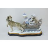 A large Lladro porcelain figure group, 'Sleigh Ride', modelled in the form of two children seated in