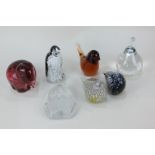 A collection of seven glass paperweights including an Australian penguin, a pair of birds, a pear,