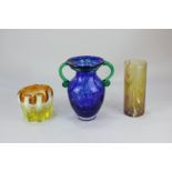 A studio glass vase of baluster form with green scroll handles and mottled blue body, together