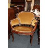 A Louis XV style mahogany tub chair, with scroll carved frame and upholstered panelled back and