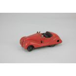 A Schuco clockwork tin plate mechanical toy motor car, Examico 4001, in red, play worn, no key