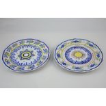A near pair of Quimper pottery cabinet plates with scalloped rims and primary colours, line