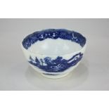 An 18th century Caughley blue and white bowl decorated with Chinese buildings in a landscape, marked