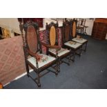 Four Jacobean style oak dining chairs including one carver, each with oval cane panel back over