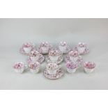 An Allertons English porcelain coffee part set with pink lustre floral design, comprising twelve