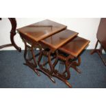 A nest of three mahogany rectangular side tables on lyre shaped supports, 51.5cm