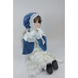 A reproduction Simon and Halbig porcelain head doll with brown hair, brown eyes and open mouth, on