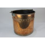 A studded copper coal bucket with brass handle, 34cm diameter