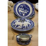 A Minton blue and white oval tureen and cover in Delft pattern, 30cm, and a matching sauce boat