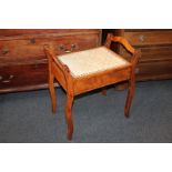 A mahogany framed piano stool with upholstered rising sea, on sabre legs (a/f)