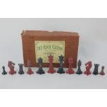 The Rose chess set, red and black painted lead pieces, in original box