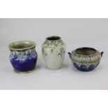Three pieces of Royal Doulton pottery including a vase with floral design, another with line