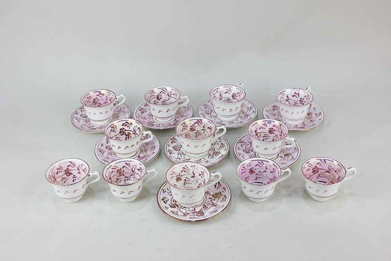 An Allertons English porcelain coffee part set with pink lustre floral design, comprising twelve