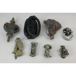 Eight various door knockers including one of a lion with ring handle, a classical profile, two imps,