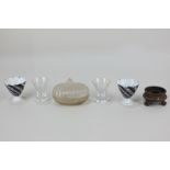 A pair of Japanese sake glasses, a Japanese carved stone box, a pair of porcelain sake cups, and a